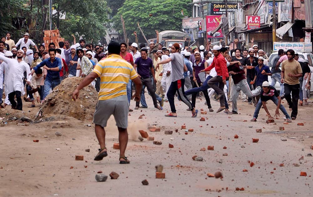 Stone pelters in action during violent clashes between two communities over a land dispute in Saharanpur.