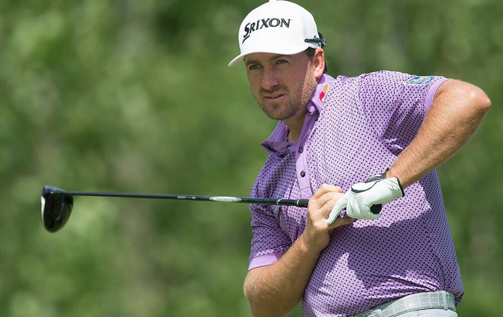 Graeme McDowell looks down the fairway after teeing off on the fourth hole during the third round of the Canadian Open golf championship at the Royal Montreal Golf Club in Montreal.