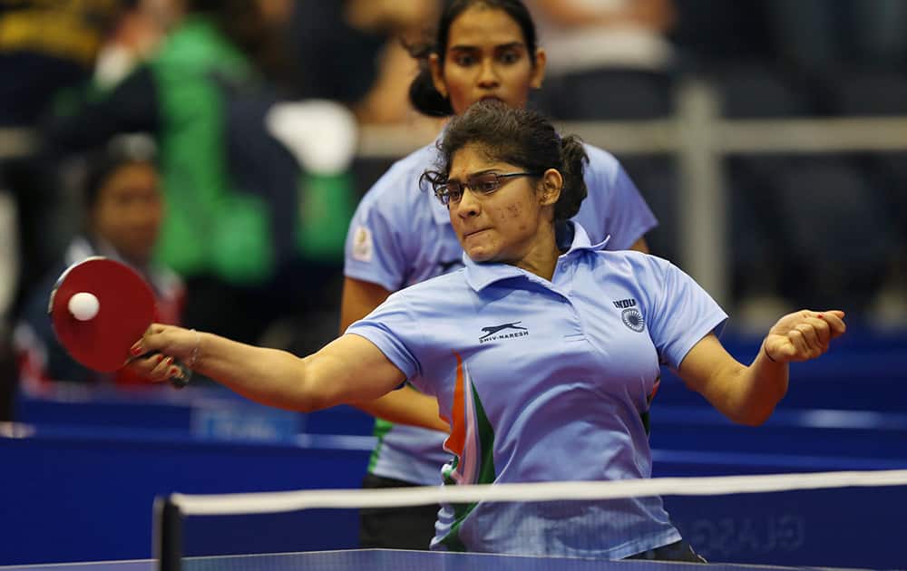India`s Madhurika Sushas Patkar and Shamini Kumaresan serve to Yang Sun and Karen Li during their women`s doubles table tennis quarterfinal match at the Scotstoun sports center in Glasgow, Scotland.