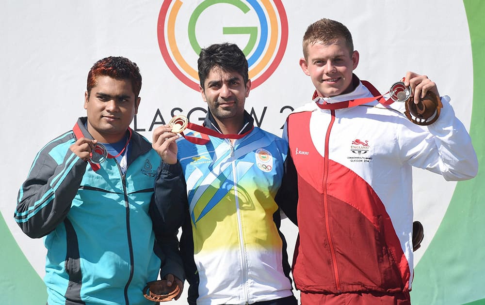 Gold Medallist India`s Abhinav Bindra, Silver Medallist Abdullah Baki of Bangladesh and Bronze Medallist Daniel Rivers of England during the medal ceremony after Men`s 10M Air Rifle event at the Commonwealth Games in Glasgow, Scotland.
