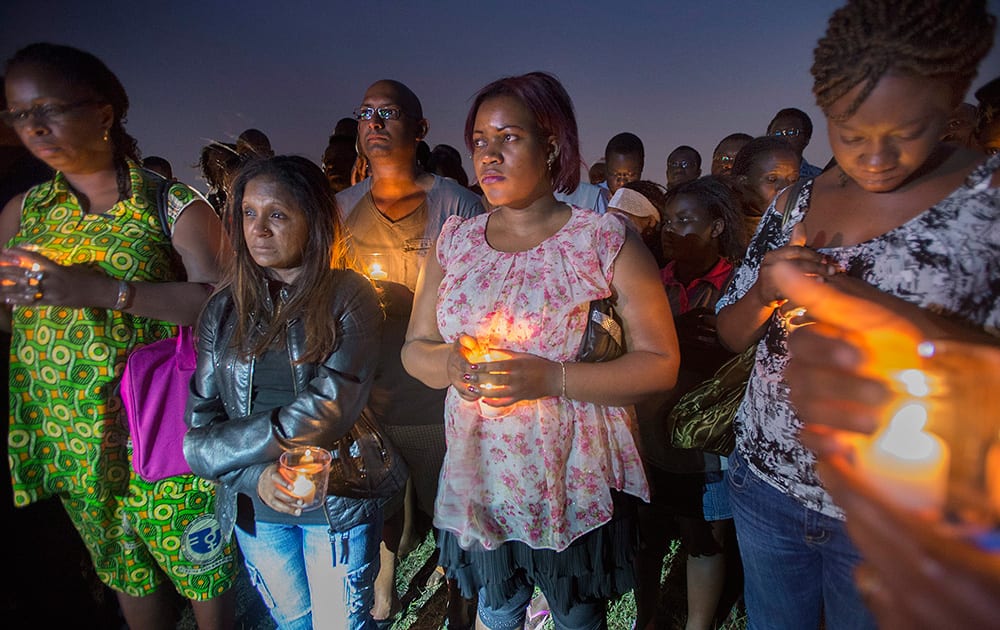 Mourners gather for a vigil at a park in Longueuil, Quebec, Canada in memory of the victims of Air Algerie Flight 5017.