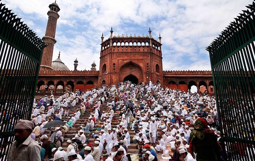 Muslims offer prayers on stairs leading to the Jama Masjid after the mosque compound got fully occupied, on the last Friday afternoon of the holy month of Ramadaan in New Delhi.
