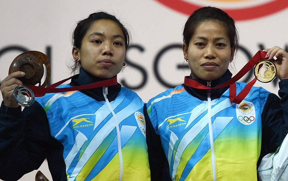 India`s gold medalist Sanjita Khumukcham and compatriot silver medalist Chanu Saikhom during the medal presentation ceremony of 48-kg women`s weightlifting event at the Commonwealth Games in Glasgow, Scotland.