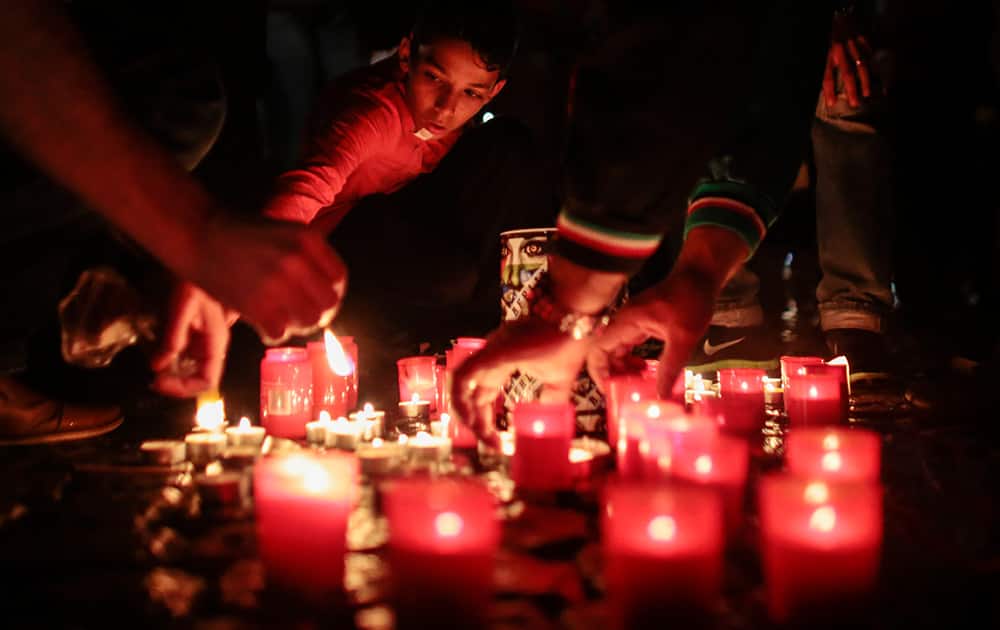Demonstrators light candles to commemorate the victims of Israel`s military offensive in Gaza at the Hermannplatz in Berlin.