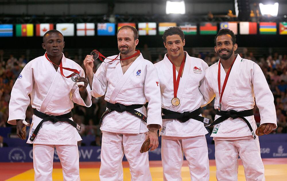 Winner England`s Ashley McKenzie, second from right, second placed India`s Navjot Chana and both third placed Jon Buchannan from Scotland and Razak Abugiri from Ghana after their Judo final bout at the Commonwealth Games 2014 in Glasgow, Scotland.