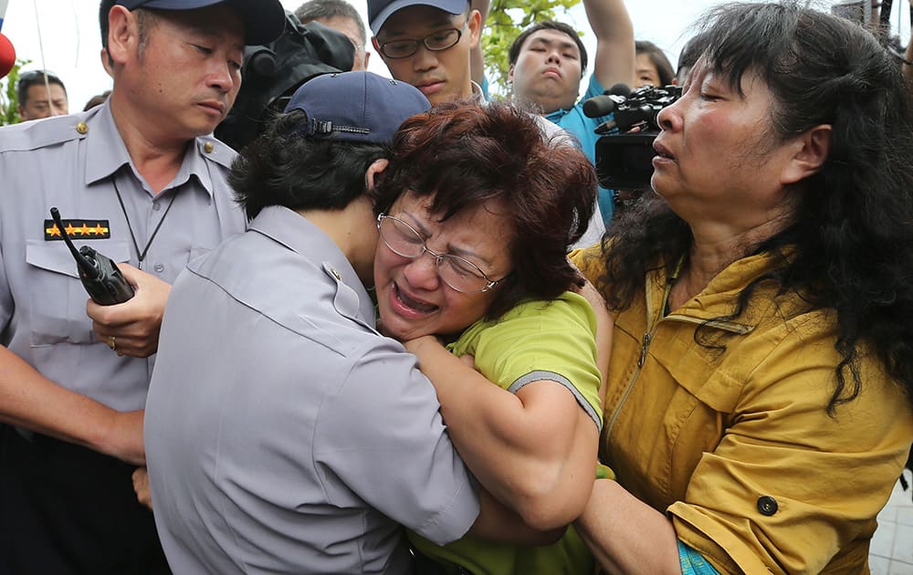 A relative of a passenger onboard the TransAsia Airways Flight GE222 that crashed on the Taiwanese island of Penghu, cries at a funeral parlor in Penghu, Taiwan.