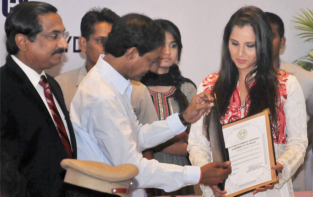 Telangana chief minister K.Chandrashekhar Rao presenting a letter of appointment as Telangana`s Brand Ambassador to Sania Mirza at ITC Kakatiya in Hyderabad.