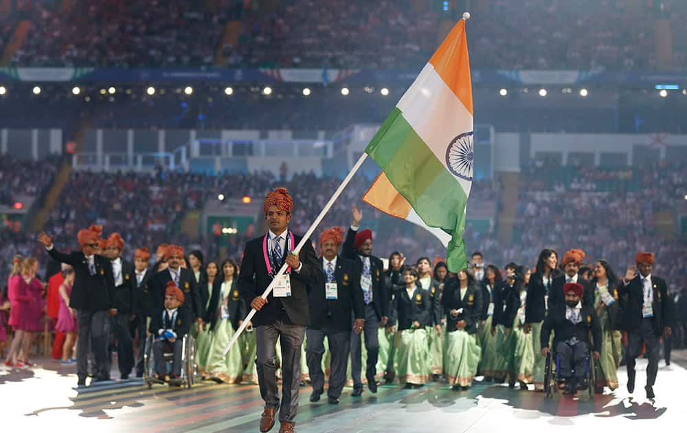 India’s flag bearer Vijay Kumar leads his team during the opening ceremony for the Commonwealth Games 2014 in Glasgow, Scotland.