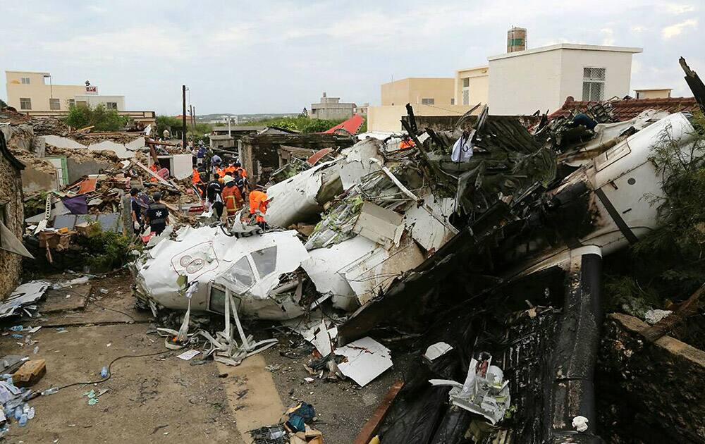 Rescue workers survey the wreckage of TransAsia Airways Flight GE222 on the Taiwanese island of Penghu.