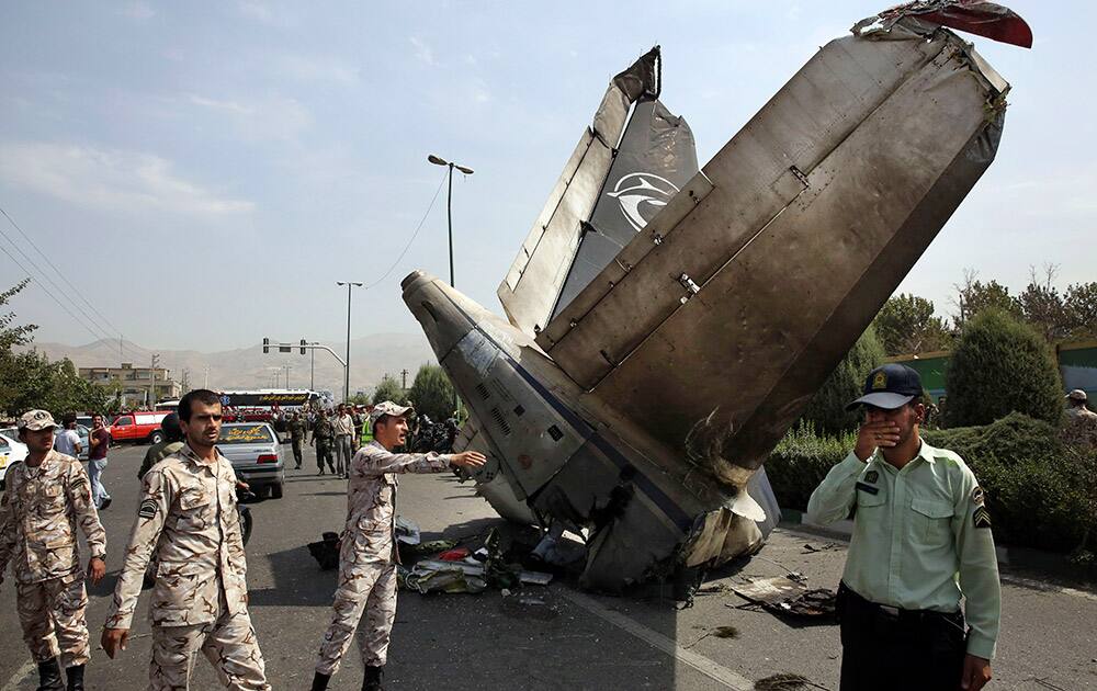 Iranian Revolutionary Guards and police officers inspect the site of a passenger plane crash near the capital Tehran, Iran.