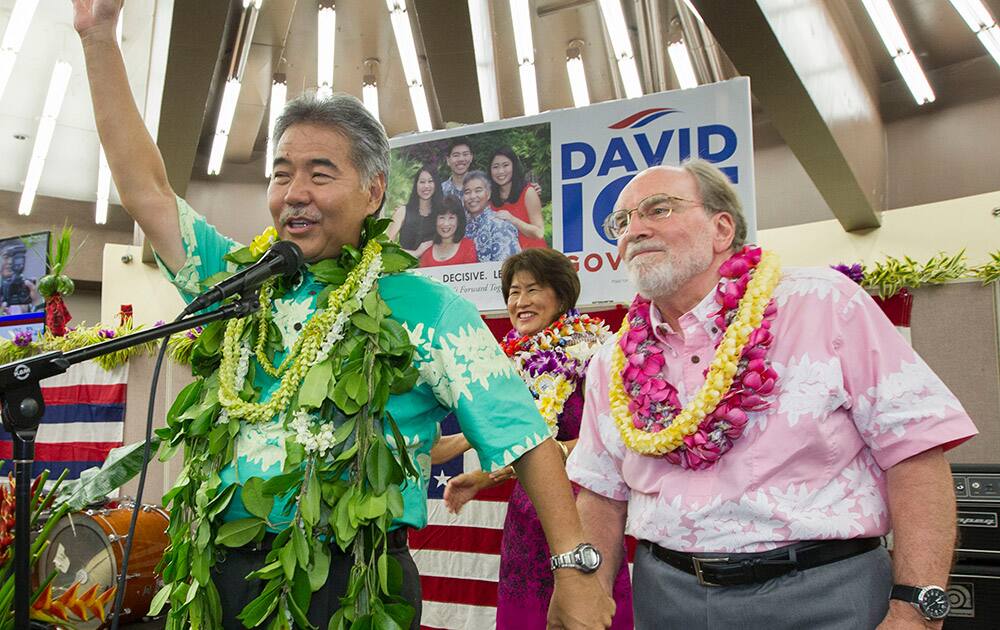 Hawaii State Sen. David Ige, right, waves to his supporters an thanks Hawaii Governor Neil Abercrombie, right, who promised his support in Honolulu.