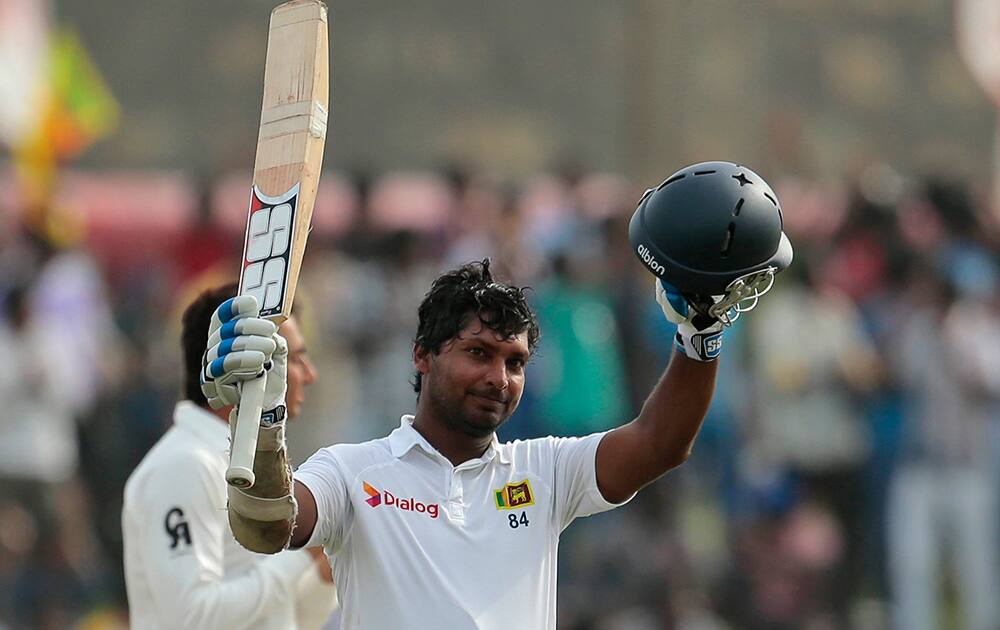 Sri Lankan cricketer Kumar Sangakkara celebrates scoring a double century during the fourth day of the first test cricket match between Sri Lanka and Pakistan in Galle, Sri Lanka.