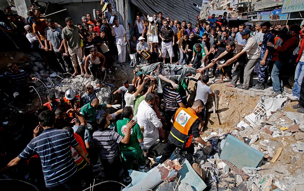 Palestinians remove the body from under the rubble of al-Qassam mosque in Nuseirat refugee camp, central Gaza Strip, after it was hit by an Israeli airstrike.