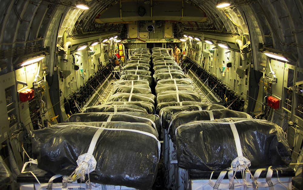 This image released by the US Air Force, shows pallets of bottled water loaded aboard a US Air Force C-17 Globemaster III aircraft in preparation for a humanitarian airdrop over Iraq.