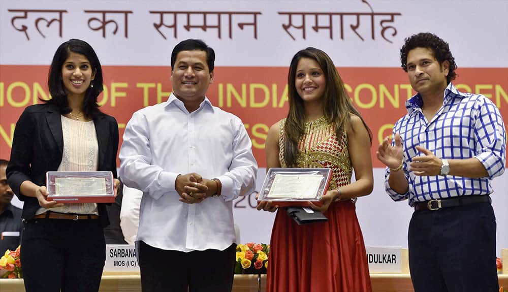 Sports Minister Sarbananda Sonowal and cricket legend Sachin Tendulkar after honoring gold medalist squash players Dipika Pallikal and Joshna Chinappa during a felicitation programme for the India`s contingent for the Commonwealth Games 2014, in New Delhi.