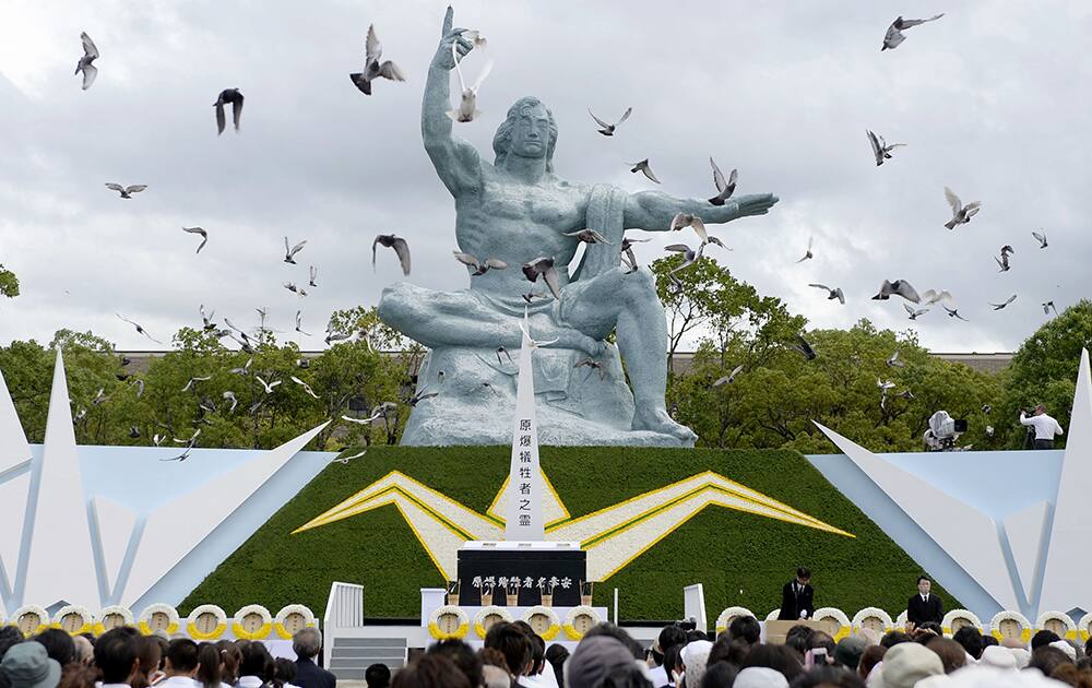 Doves fly over the Statue of Peace during a ceremony at Nagasaki Peace Park in Nagasaki, southern Japan.