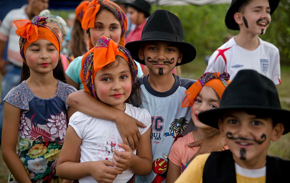 Romanian Roma children pose before performing in an anti-discrimination play during a solidarity event in Bucharest, Romania.