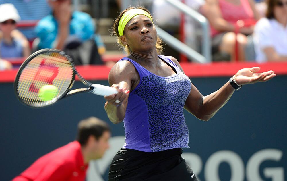 Serena Williams returns to Caroline Wozniacki, of Denmark, at the Rogers Cup tennis tournament, in Montreal.