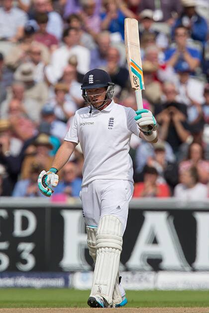 England`s Ian Bell raises his bat as he reaches 50 at Old Trafford cricket ground on the second day of the fourth test match of his side`s five match series against India, in Manchester, England.