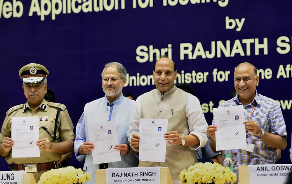 Union Home Minister, Rajnath Singh with Lieutenant Governor of Delhi, Najeeb Jung, Union home secretary Anil Goswami and Delhi Police Commissioner, B S Bassi at the launch of a web application of Delhi Police for issuing Police Clearance Certificate, in New Delhi.