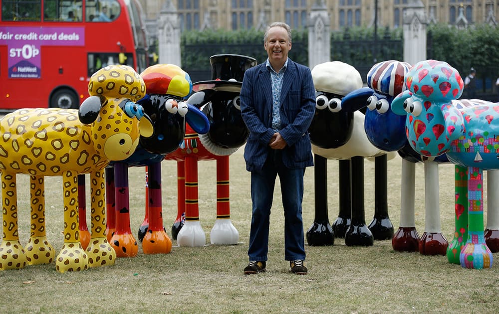 British director Nick Park, the creator of the Wallace & Gromit animated movies, poses for photographers with six sculptures of his animated character Shaun the Sheep in London.