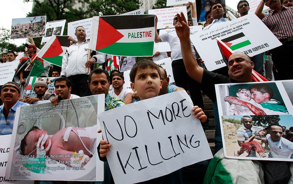 People from the Middle Eastern countries and now living in South Korea, shout slogans during a rally against the Israeli military operations in Gaza and wish for peace near the Israeli Embassy in Seoul, South Korea.