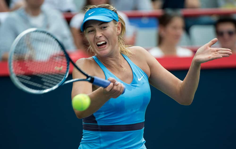 Maria Sharapova, of Russia, returns to Carla Suarez Navarro, of Spain, during the round of sixteen at the Rogers Cup tennis tournament.