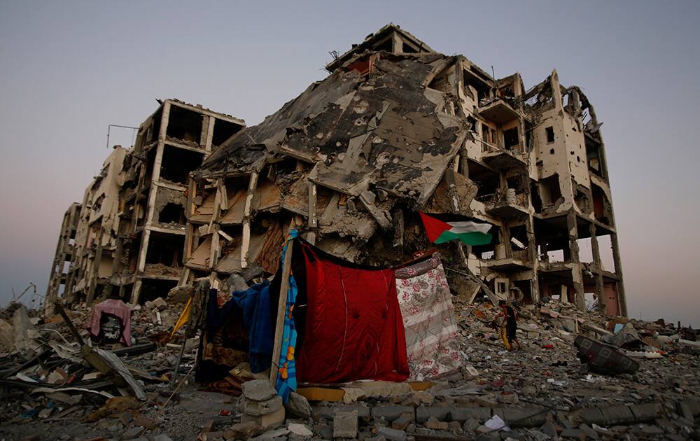 A makeshift tent stands near to the destruction of buildings at a residential neighborhood, in Beit Lahiya, northern Gaza Strip.