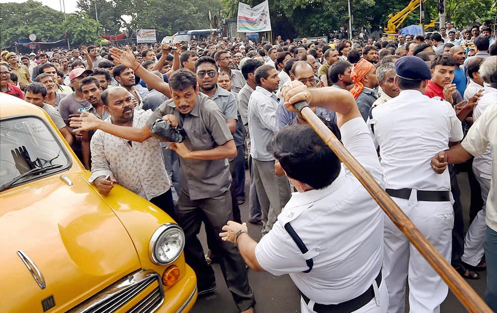 Police lathi charge taxi drivers during a protest against the West Bengal government in Kolkata.