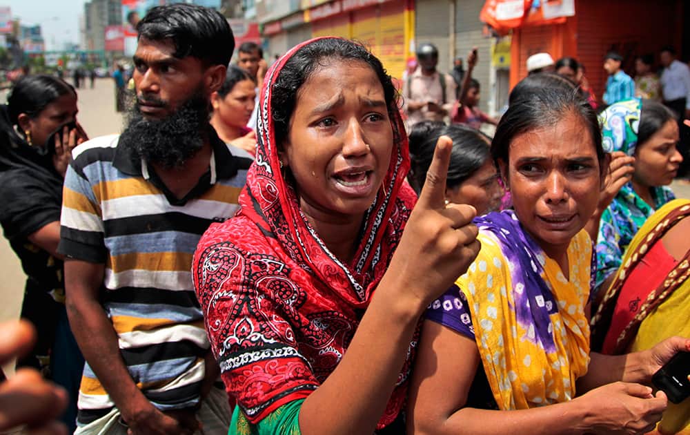 A Bangladeshi garment worker reacts before the media after police baton charged them in Dhaka, Bangladesh.
