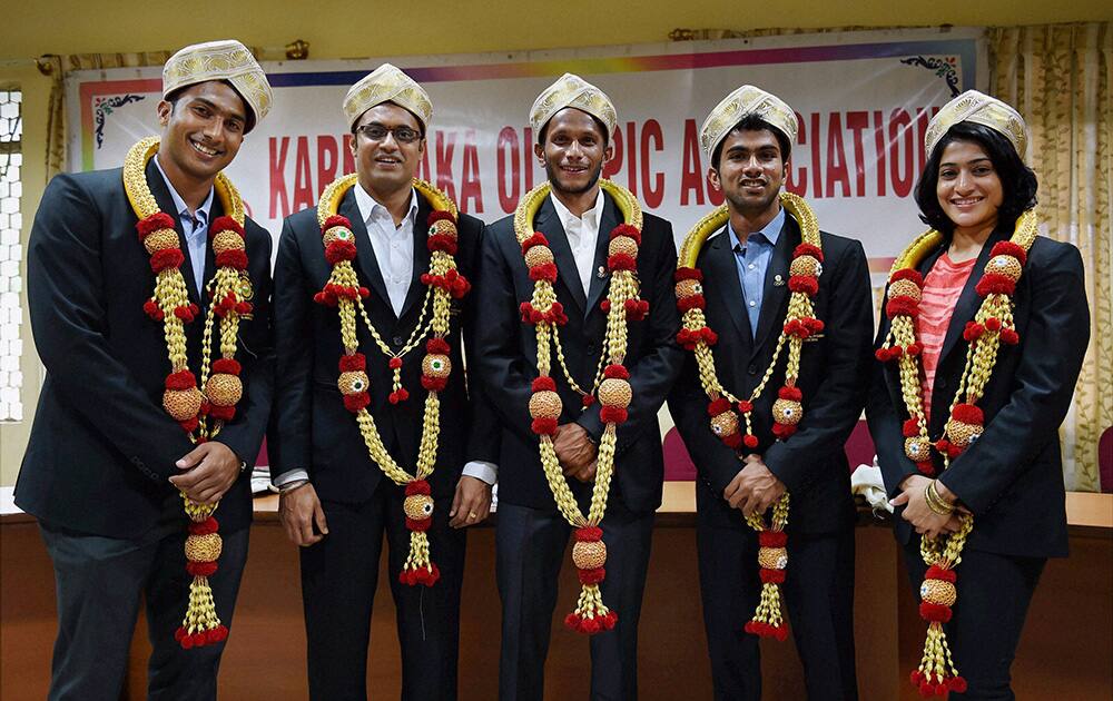 CWG medalists, Prakash Nanjappa (shooting), hockey players V R Raghunath, Nikin thimmaiah, S V Sunil and shuttler Ashwini Ponappa wear Mysore peta during a felicitation programme by Karnataka Olympic Association in Bengaluru.