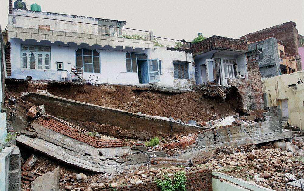 Household goods and appliances lying scattered after a house collapsed near a drain injuring three people in Thane.
