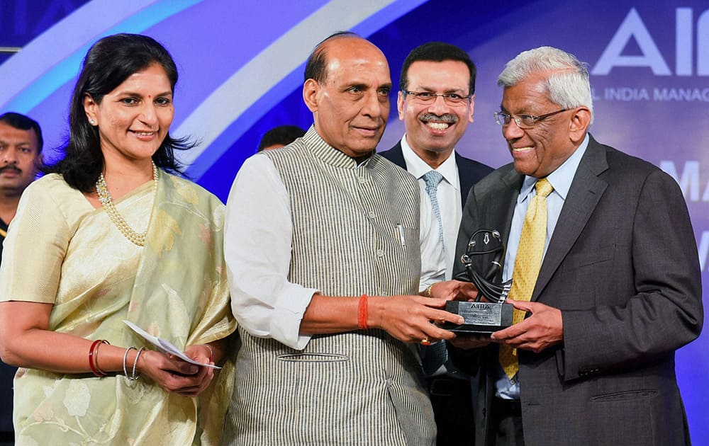 Union Home Minister Rajnath Singh presents Emerging Business Leader of the Year 2014 to Deepak Parekh, chairman, HDFC during the AIMA managing India awarrds 2014, in New Delhi.