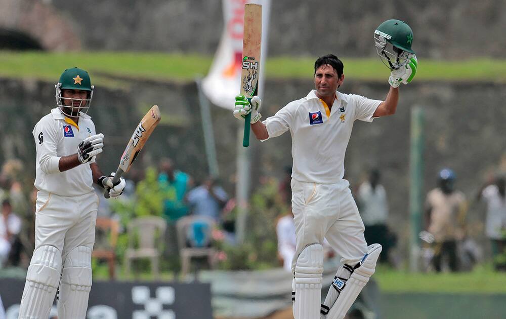 Pakistani cricketer Younis Khan raises his bat after scoring 150 runs as teammate Sarfraz Ahmed applauds during the second day of the first test cricket match between Sri Lanka and Pakistan in Galle, Sri Lanka.