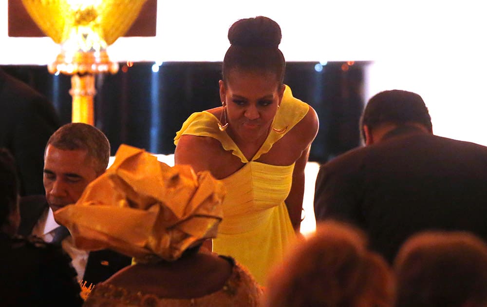 First lady Michelle Obama takes her seat after toasting guests following President Barack Obama`s offering of a toast at a dinner for the U.S. Africa Leaders Summit, on the South Lawn of the White House.