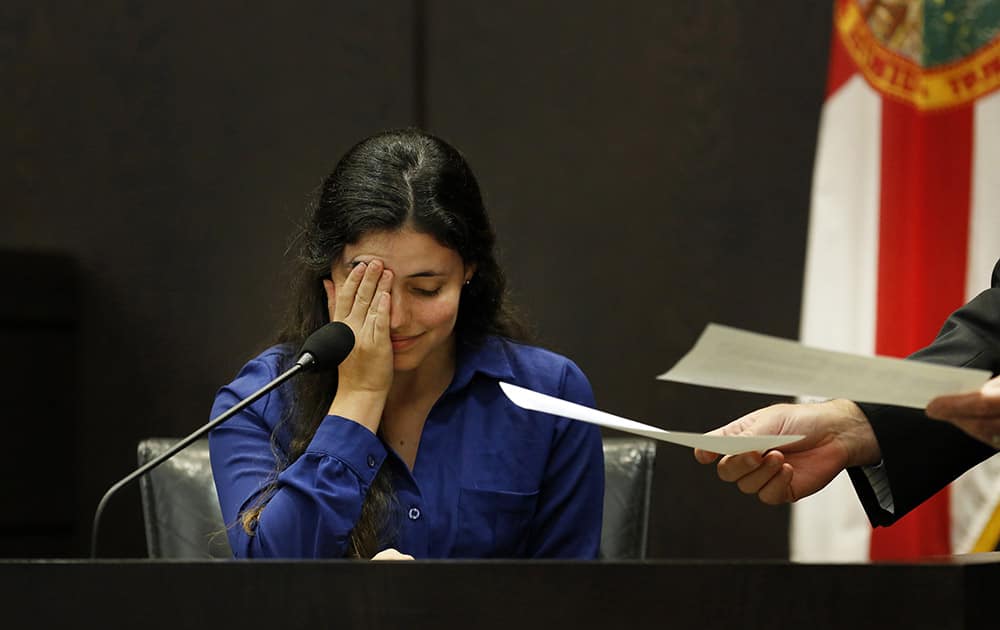 Erika Friman, the girlfriend of slain University of Florida student Christian Aguilar, pauses during the reading of a series of text messages between her and former boyfriend Pedro Bravo while on the stand in Bravo`s murder trial at the Alachua County Criminal Justice Center in Gainesville, Fla.
