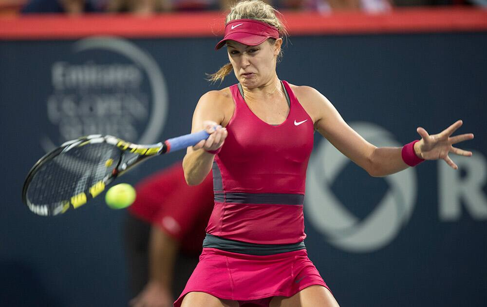 Eugenie Bouchard, from Montreal, returns to Shelby Rogers, of the United States, at the Rogers Cup tennis tournament in Montreal.