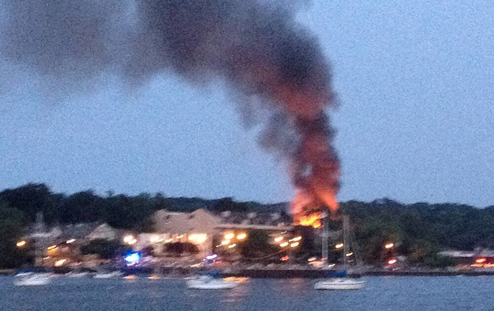 Flames and smoke emerge from a building in Port Washington, N.Y. The Port Washington police say no injuries have been reported. The circumstances of the blaze are unclear.