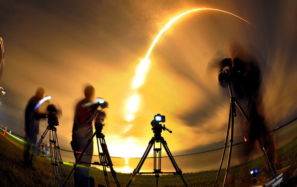 The media watches as a Space X falcon 9 rocket carrying the AsiaSat 8 Satellite liftoff from the Cape Canaveral, Fla., Air Force Station.