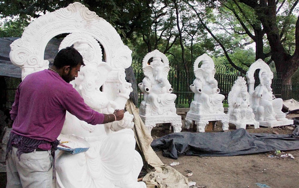 An artist giving final touches to a Ganesh idol ahead of Ganesh Chaturthi festival in Allahabad.