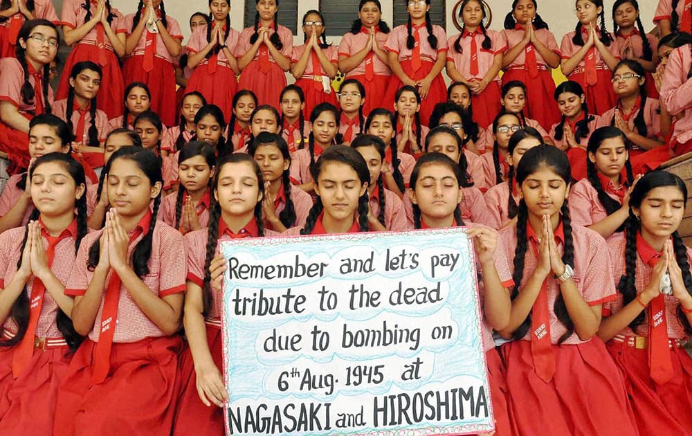 Children paying tributes to the victims of Hiroshima and Nagasaki bombings at a school in Moradabad.