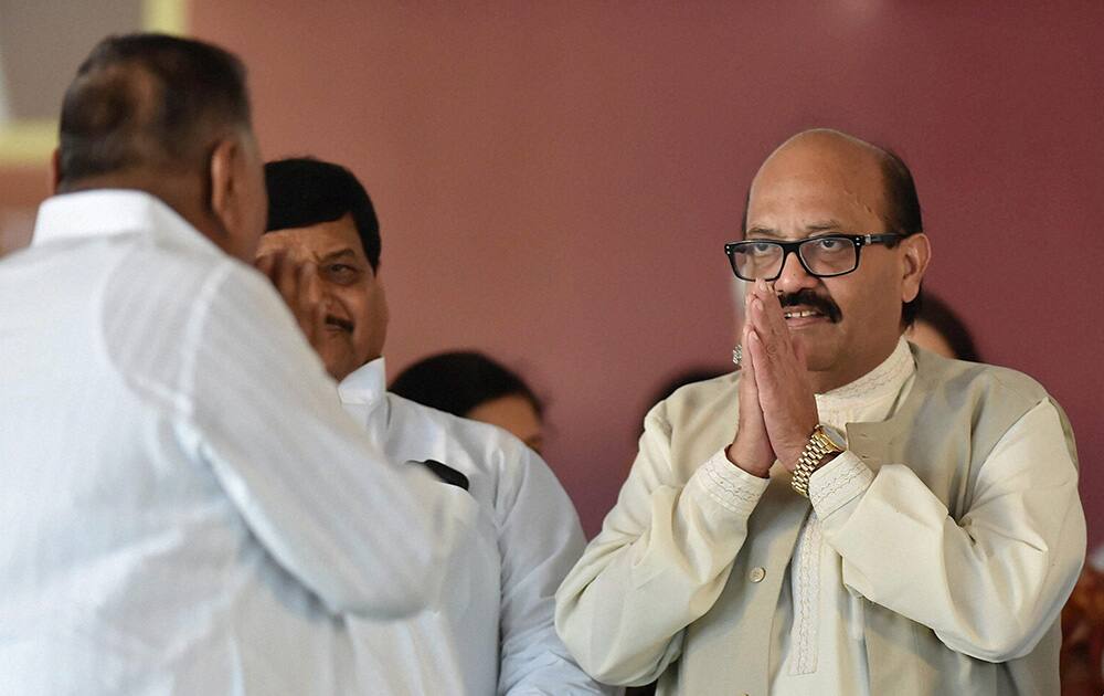 Samajwadi Party President Mulayam Singh Yadav exchanges greetings with party`s expelled leader Amar Singh at the inauguration of Janeshwar Misra Park in Lucknow.