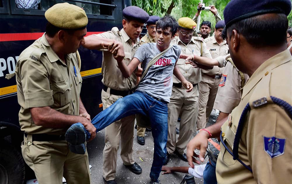 Security personnel hold one of the IETE students protesting outside HRD Minister Smriti Irani`s residence in New Delhi.