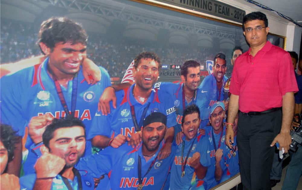 Former Indian cricket captain Sourav Ganguly poses before a poster of the 2011 World Cup winning Indian team after being elected the Joint Secretary of CAB (Cricket Association of Bengal) in Kolkata.