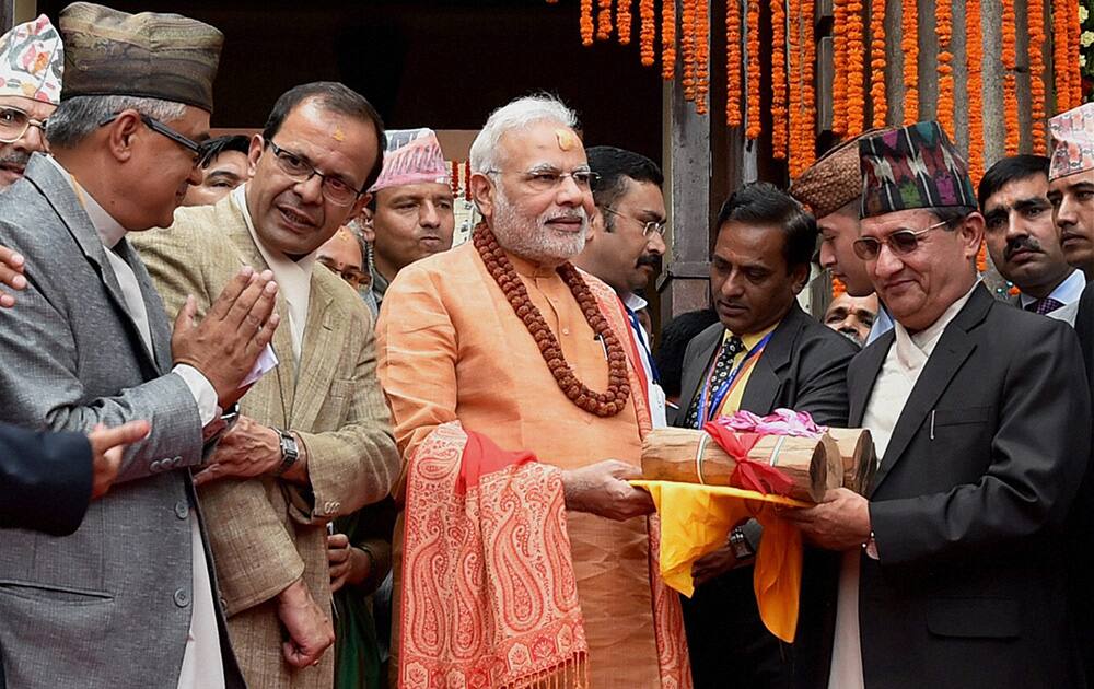Prime Minister Narendra Modi gifts sandalwood to the Pashupatinath temple after praying at the temple in Kathmandhu, Nepal.