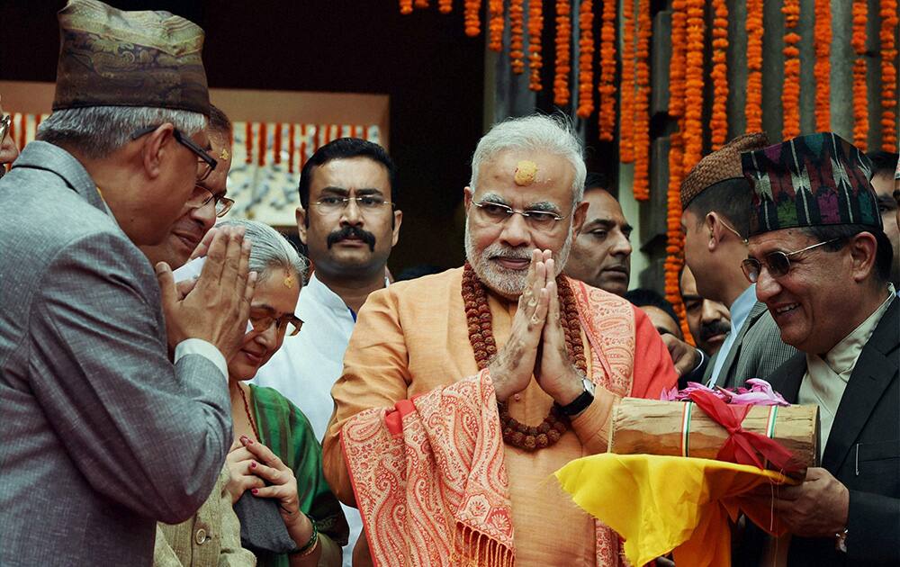 Prime Minister Narendra Modi gifts sandalwood to the Pashupatinath temple after praying at the temple in Kathmandhu, Nepal.