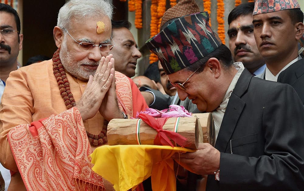 Prime Minister Narendra Modi gifts sandalwood to the Pashupatinath temple after praying at the temple in Kathmandhu, Nepal.