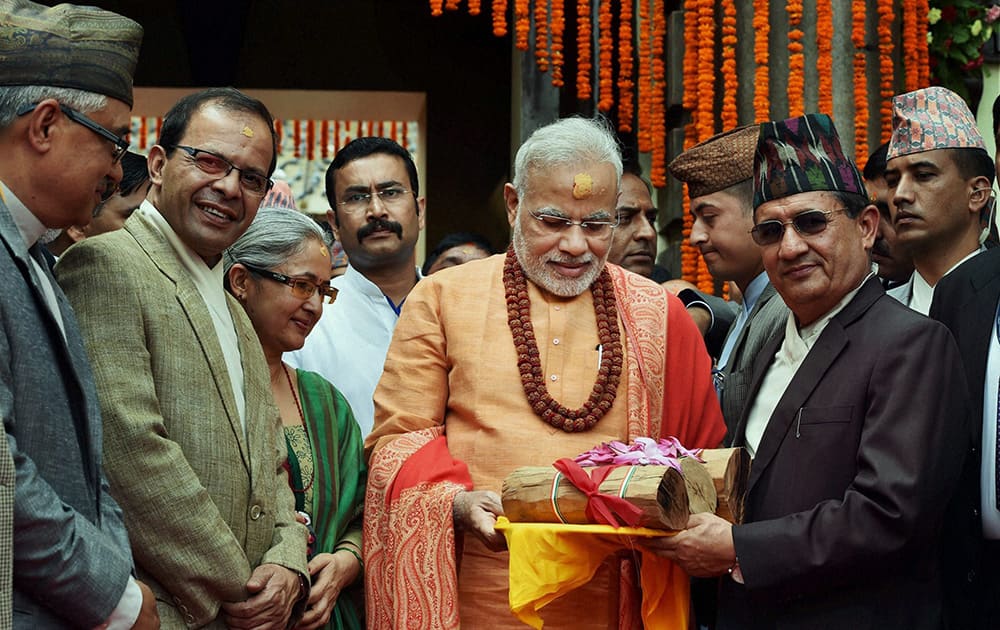 Prime Minister Narendra Modi gifts sandalwood to the Pashupatinath temple after praying at the temple in Kathmandhu, Nepal.