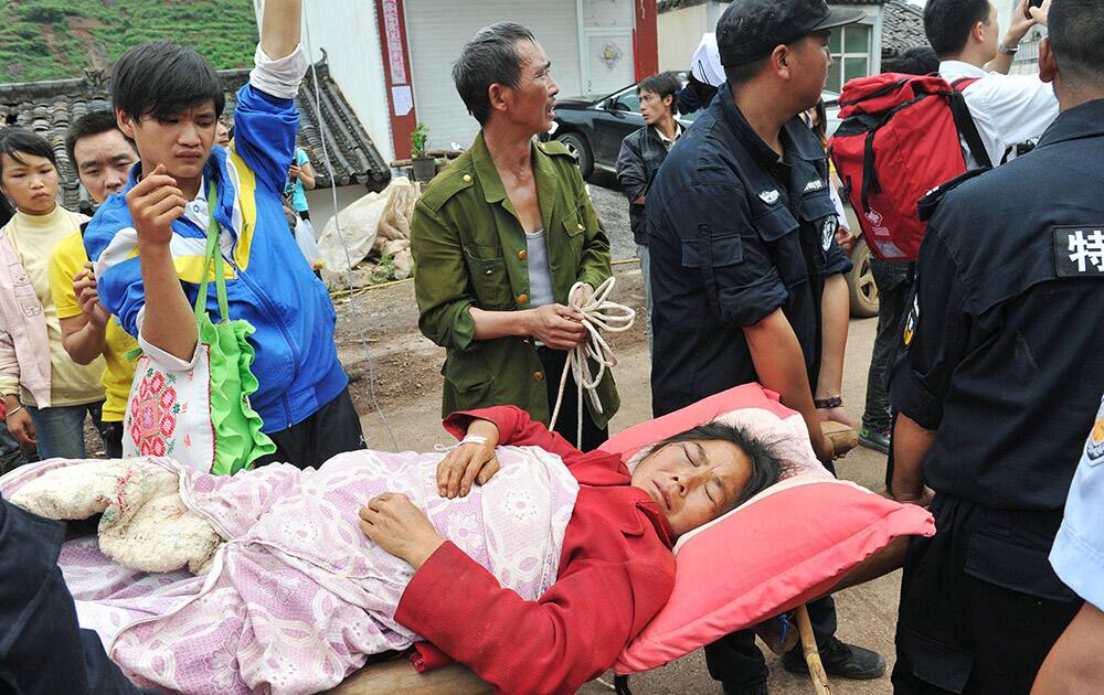 A woman is rescued in Ludian County of Zhaotong City in southwest China`s Yunnan Province, following Sunday`s strong earthquake.