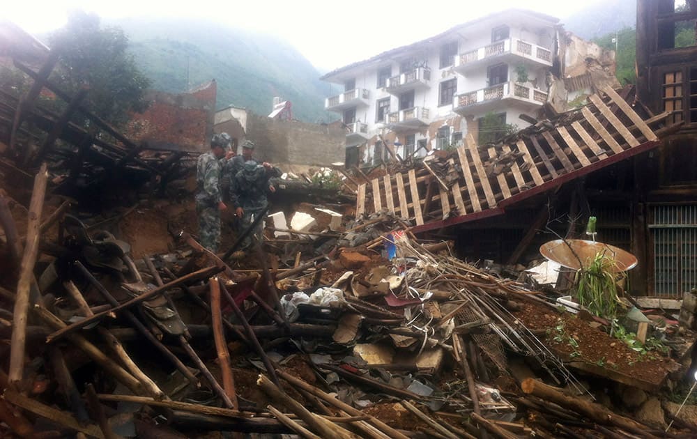 Rescue workers search for survivors in the epicenter of an earthquake that struck the town of Longtoushan in Ludian county in southwest China`s Yunnan province.